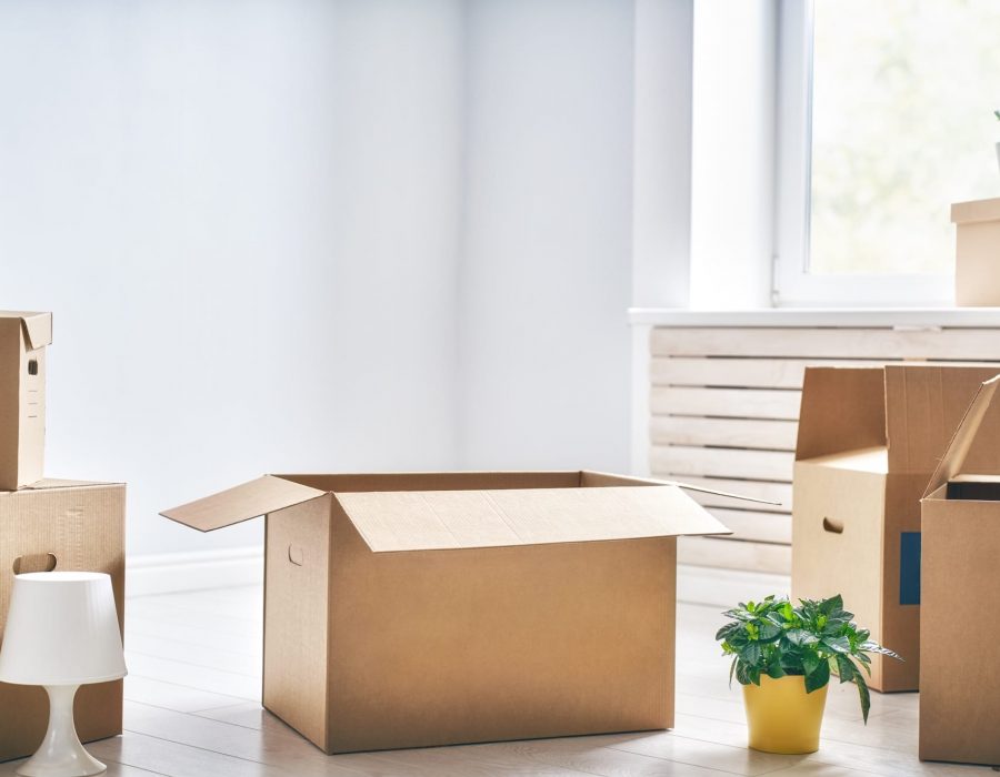 Cardboard boxes in empty new apartment.