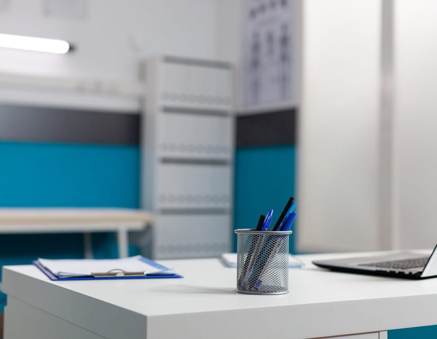 Close up of white desk in empty doctors office at clinic with laptop computer, documents and tools for examinations. Nobody in cabinet workplace for person with medic occupation SSUCv3H4sIAAAAAAAACpySy27rIBCG90fqO0Ssi4S5JfRVjs5iBsYJqmMijFtVVd+9+BaxPjvPN7d/fvP98ud0YghT9Ozt9L1ENY7DME8lQ4lprFi87jzTGCi35CMrK1pAIZaUIwwtRCj+NsKdKhznYVjwz5pkU4EyTzQt23fkodC1ztjgc8Qm8e8Wn47EmqwdNcXYa8OmGVd2oG34f3VuH/+Oa+BKo/9aBTeHZBoItkN2jewirJNn6bk0nri2iBwCCe4Ruy5I05Ozx2bW9R7QKuKiR8G1lIojaM2tRCSFykvXPYulc96gUVyES8+18Zo7qz3vrLXKOROcxlX/Jpq9fxbK99ZkmENMjb8fycOwFKjmpkeOPo7Xpi2V2/oAjjaf5rHkxYynh2xI6QE4LD+7rzPp4DeYploeDt4s8vW5pXuzZ0xltXKfykJ9E0vYqWqoMU46K6Spl7q9YHtHt1jnrHKOQTX27zG0p8dFAXOk6SygWngWhutLMByVMdx0gI6UPxtS1cKfXwAAAP//AwDsSNBoIgMAAA==