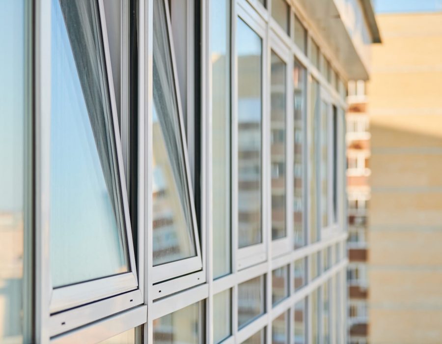 PVC windows on facade of skyscraper. Plastic double glazed windows. Building exterior.